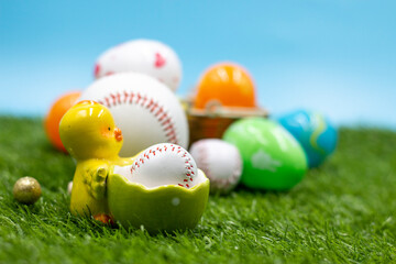 Fototapeta na wymiar Baseball for Easter Holiday with decoration on blue sky background