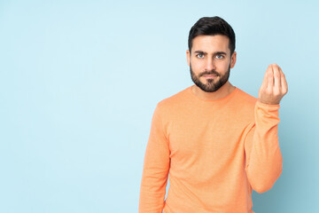 Fototapeta premium Caucasian handsome man making Italian gesture over isolated blue background
