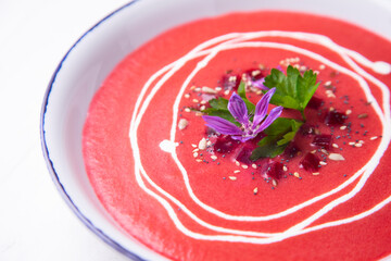 Beetroot gazpacho decorated with flowers