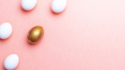 Easter flat. Golden, white colour egg on pastel pink background in Happy Easter decoration. Spring holiday top view concept.