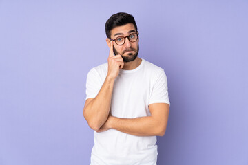 Caucasian handsome man over isolated background thinking an idea