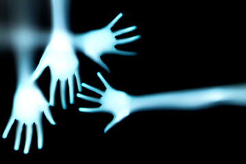 shadow of a hands behind transparent paper