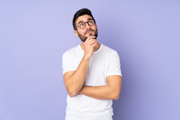 Caucasian handsome man over isolated background and looking up