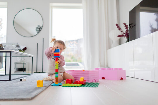 Toddler girl playing with building blocks