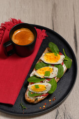 Meal with boiled eggs, toast, yogurt and spinach