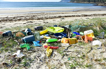 Beach with plastic pollution on sand at famous Rias Baixas Region. Galicia, Spain.