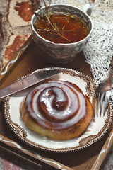 Delicious cinnamon roll buns with cheese glaze served with herbal rtanj tea