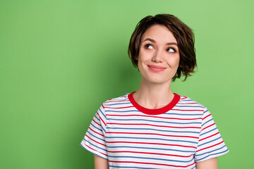 Fototapeta premium Photo of pretty positive lady look interested empty space imagine thinking isolated on green color background
