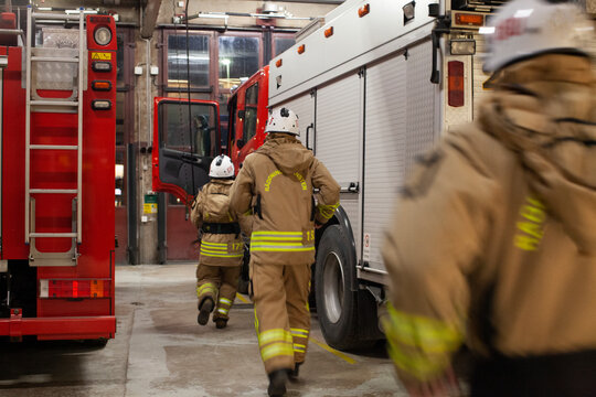 Firefighters walking into fire engine
