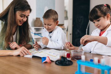 Fototapeta premium children do chemical experiments at home