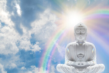 Buddha Enlightenment Rainbow Sky Message Background - peaceful contemplative Buddhist in lotus position meditating with a rainbow sunburst and dramatic cloudy background with copy space

