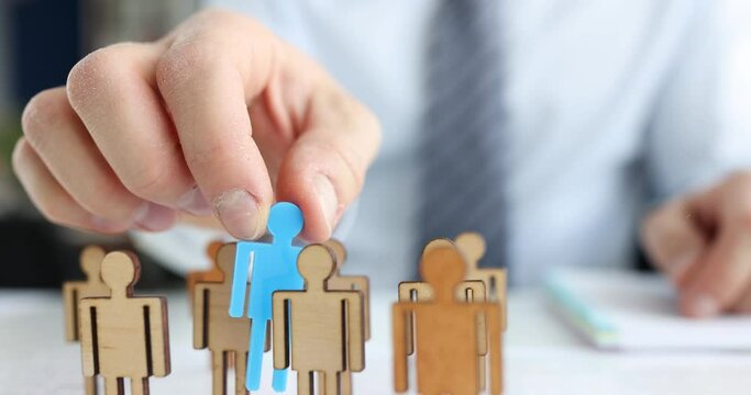 Businessman puts special person in middle of identical figures. Opening startup concept