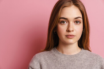 Fototapeta premium Portrait of a lovely attractive young girl isolated over pink