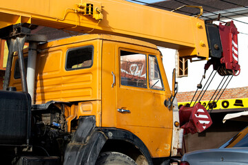 Yellow car crane. A sunny autumn day is a side view.