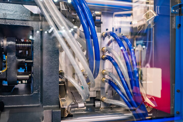 Mold plates - part of automatic injection molding machine at exhibition, trade show. Manufacturing,...