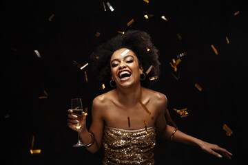 Happy african american woman in party dress drinking champagne - obrazy, fototapety, plakaty