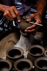 Fototapeta na wymiar Professional thai old man using mechanic pottery made earthenware at Koh Kret in Nonthaburi Thailand