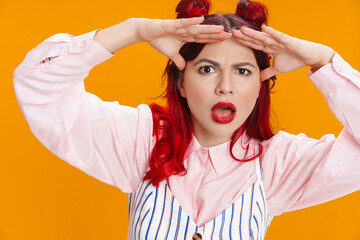 Shocked girl with red hair posing and looking at camera