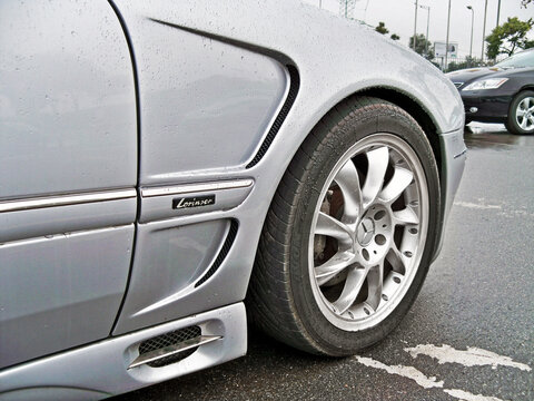 Kiev, Ukraine - August 18, 2010: Grey Mercedes-Benz CL 500 Lorinser. Car tires. Car wheel close-up. Car in raindrops
