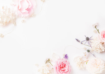 Flowers composition. Frame made of pink rose flowers on white background. Flat lay, top view, copy space