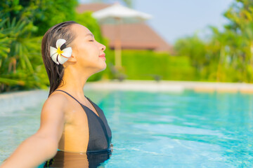 Portrait beautiful young asian woman relax smile enjoy leisure around swimming pool