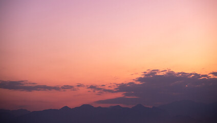 Naklejka na ściany i meble Orange sky over silhouette mountain in the morning.