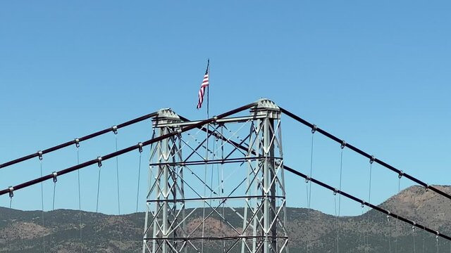 USA flag on suspension tower supporting the bridge over Royal Gorge, Colorado