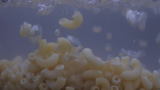 macaroni pasta in pot with boiling water 4k