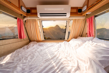Mattress in camper van and beautiful landscape while road trip traveling on vacation
