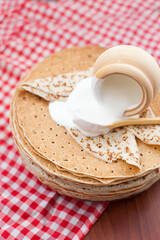 Russian pancakes or blini with sour cream . Top view. Pancake week