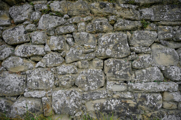 Grey textured stone wall background close-up. Copy space.