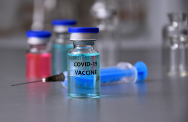 Ampoules COVID-19 vaccine on laboratory background stock images. Covid 19 vaccine with syringe and glass laboratory equipment images. Laboratory accessories stock photo