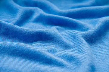 Fototapeta na wymiar The texture of a knitted woolen fabric blue.
