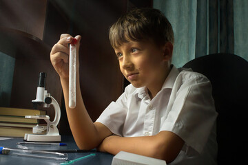 cute male child experiments with test tube at home