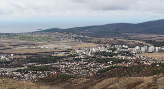 Winter landscape, view from the top of the mountain to the sea resort city of Gelendzhik. Close-up with a blur effect and miniatures of buildings. A photo with a tilt-shift effect. Russia, Black sea