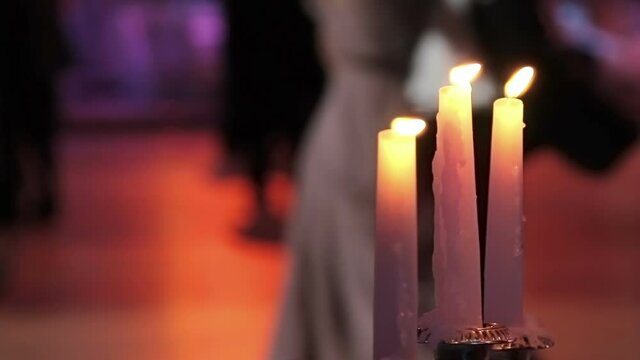 Dancing couples, burning candle and beautiful flowers. Traditional Vienna ball.