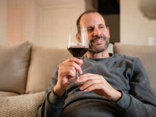 MAN WITH GLASS OF WINE IN HAND