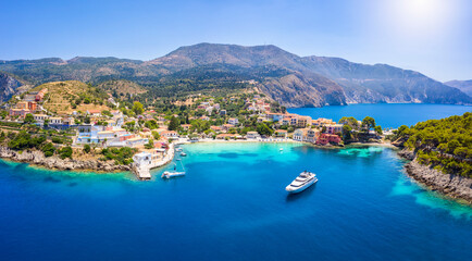 Fototapeta na wymiar Aerial view to the beautiful fishing village of Assos on the island of Kefalonia, Greece, surrounded by turquoise sea and green hills with Pine Trees