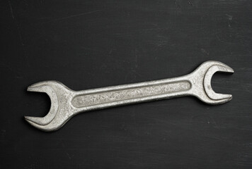metal wrench for nuts on a black background