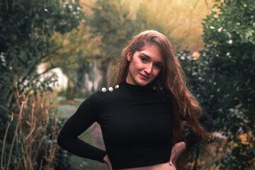 Young caucasian woman with casual clothes posing in the the forest.