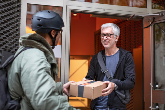 Bicycle courier delivering parcel