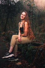 Young caucasian woman with casual clothes posing in the the forest.