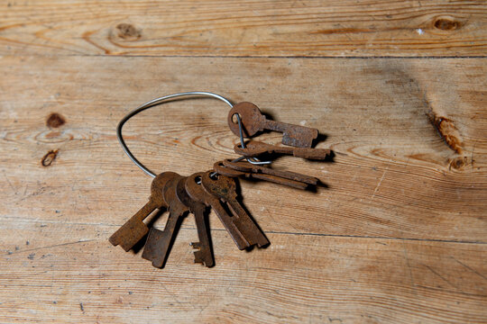 Rusty keys on wooden background