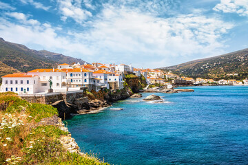Panorama of the beautiful town of Andros island situated on rocks over the Aegean sea, Cyclades, Greece
