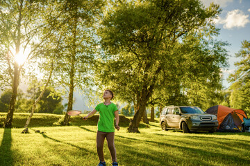 one young boy playing in badminton outdoors