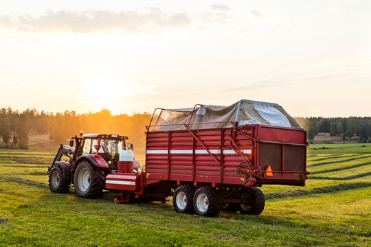 Tractor with loader wagon in field