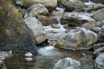 Naklejka na ściany i meble Wild river flow with rocks landscape in Taiwan.