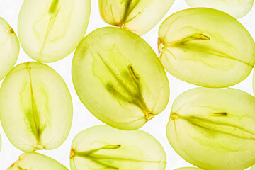 Halves of green grapes on white background, pattern.