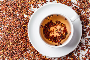 Brown rice tea in white cup.