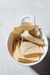 Dry herbal tea bags in white bowl. Herbal tea concept.